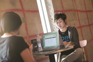 Inside the funky space, Jenn Lim from Delivering Happiness gets prepared for her Fireside Chat and stays productive.