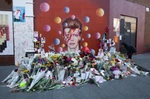 Floral tributes are placed in front of a mural of Bowie in Brixton, south London. (JUSTIN TALLIS/AFP/Getty Images)